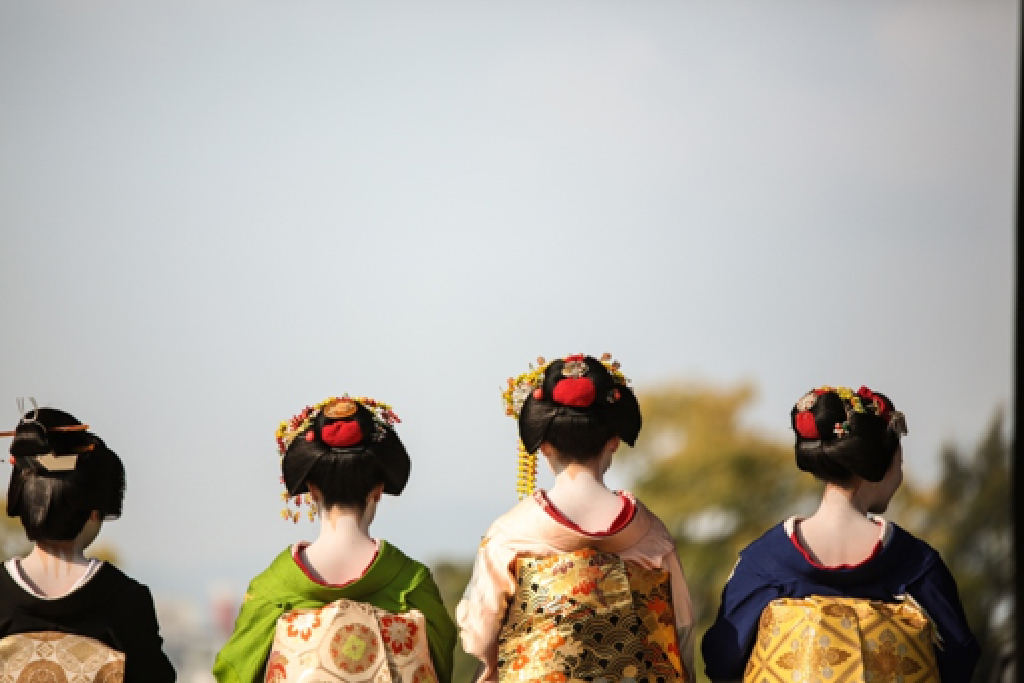 Image shows four geisha's from the back